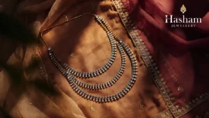 Layered artificial necklaces styled on embroidered Eastern fabric
